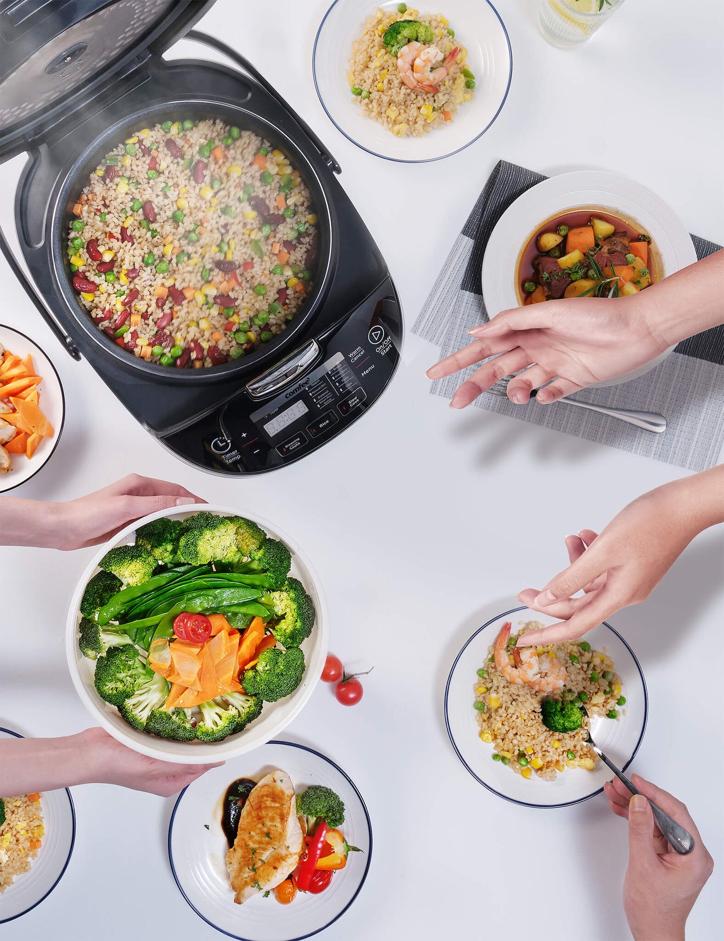 rice cooker with rice inside surrounded by various meals