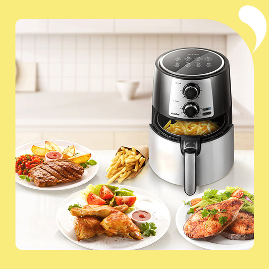 comfee digital air fryer with fries inside in front of a steak chick and fish meal