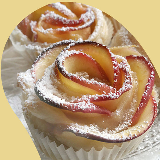 apple rose tarts with powdered sugar on top