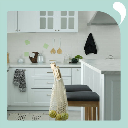 a bright, modern kitchen with white cabinets and minimalist decor.