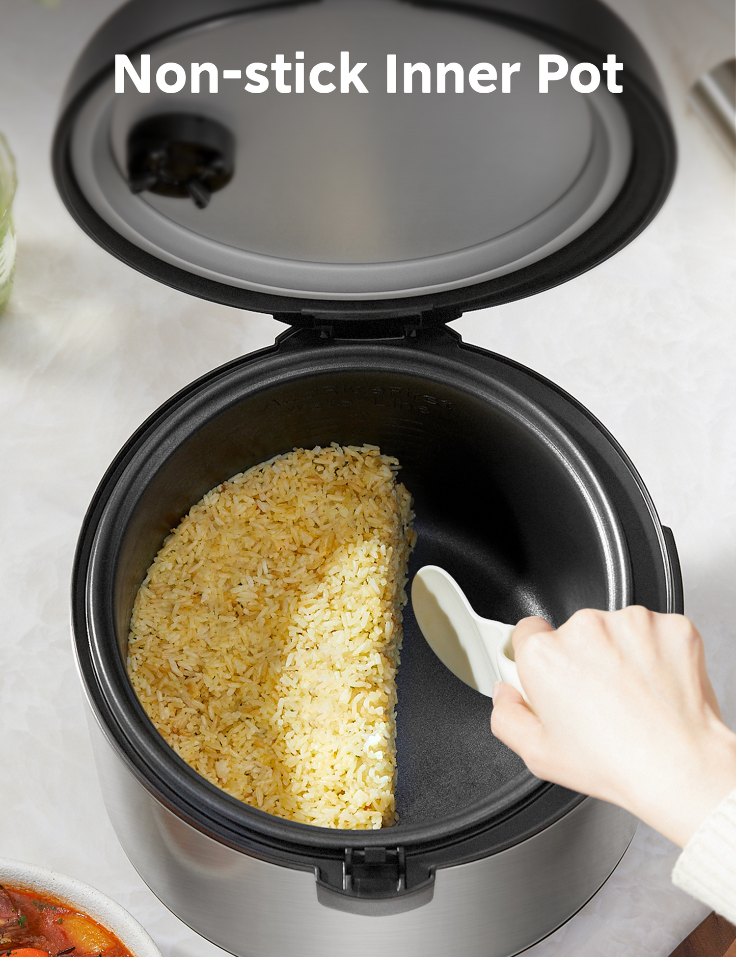 overhead view of rice inside a stainless steel pot