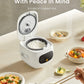 mini rice cooker with rice inside surrounded by various meals