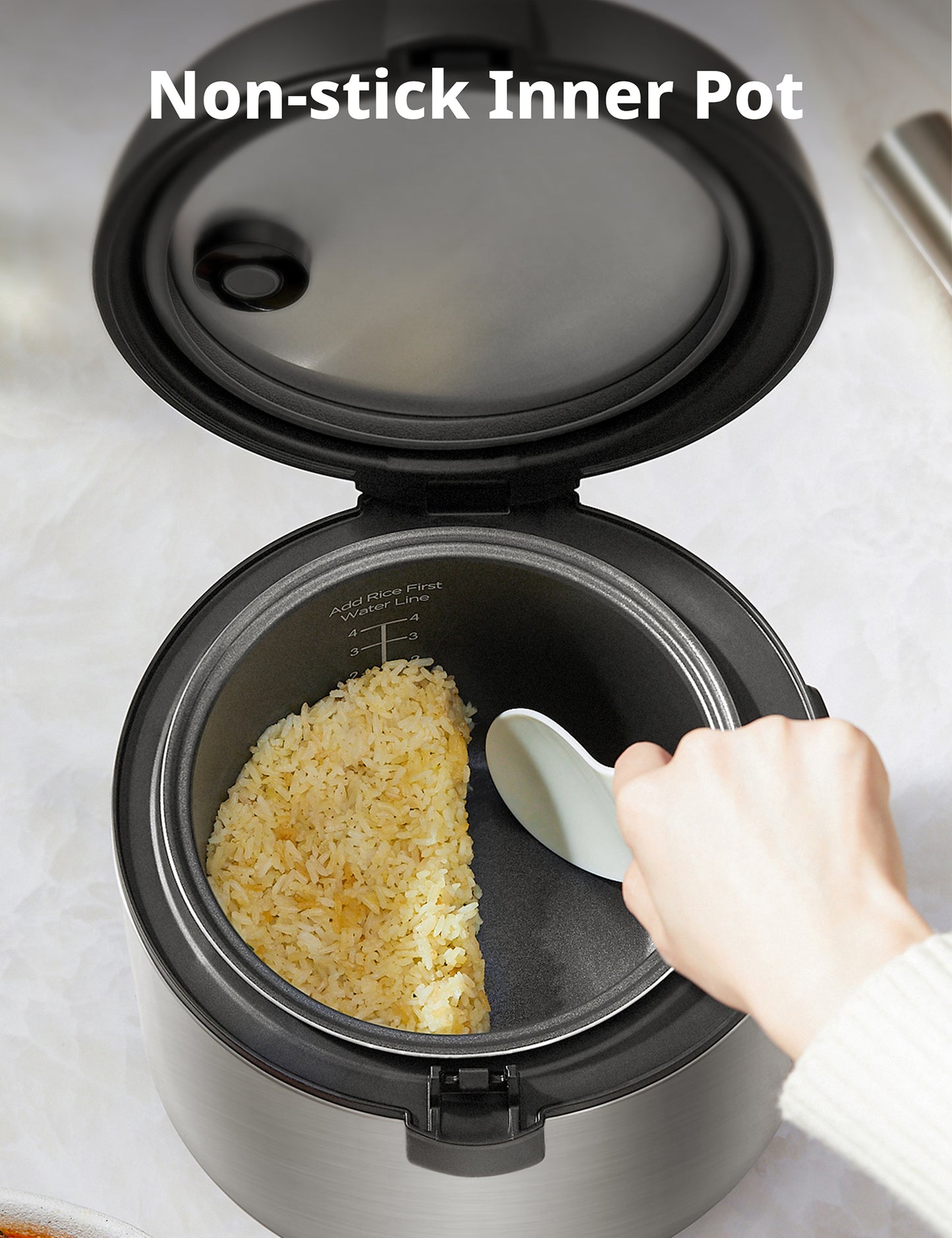 overhead view of non stick rice cooker pot with rice inside