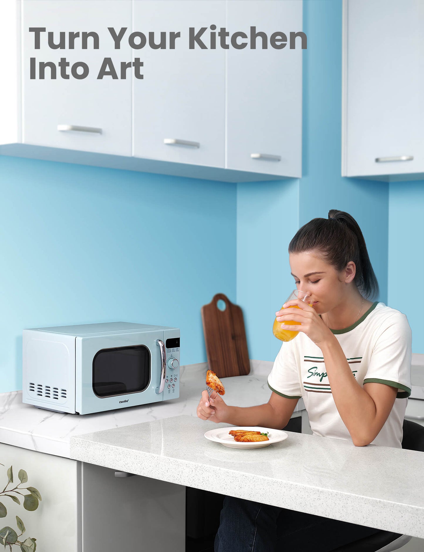 a woman is drinking orange juice and eating chicken wings with a microwave oven next to her