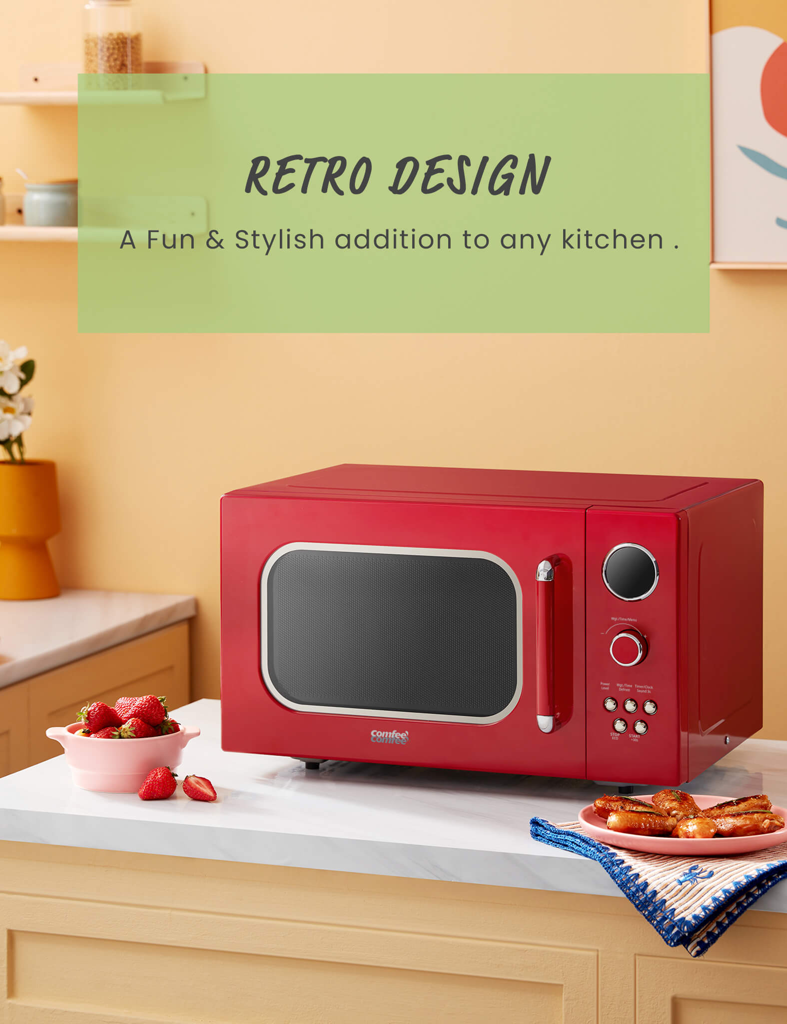 red comfee retro microwave on a kitchen countertop next to a bowl of strawberries