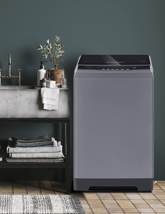 dark grey portable washer next to a sink with towels on the below shelf