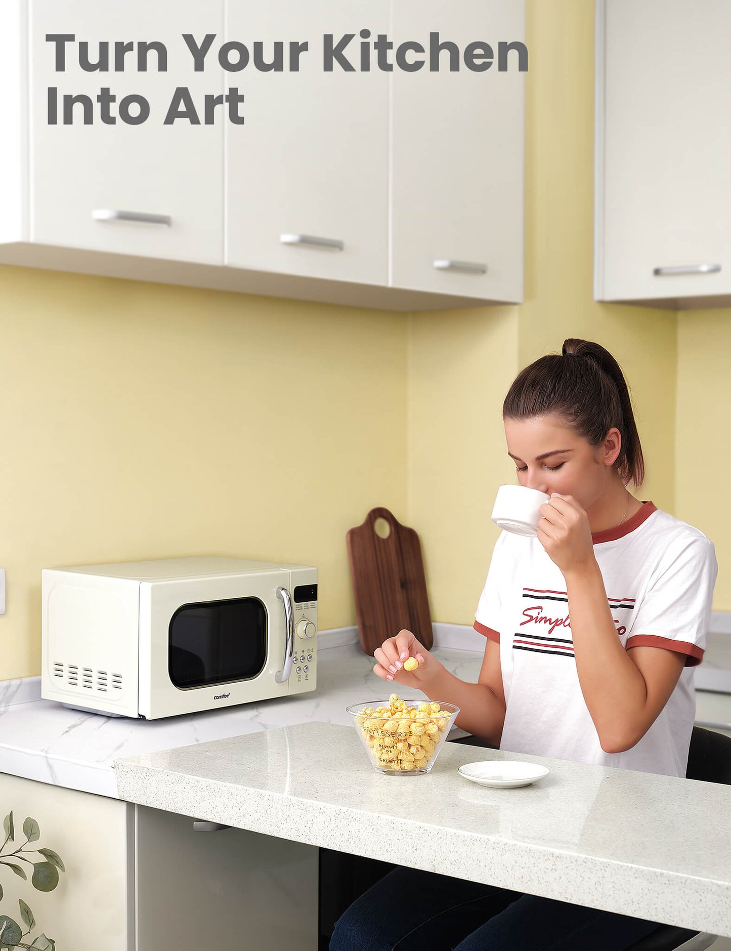 a girl drink a cup of tea with popcorn next to microwave