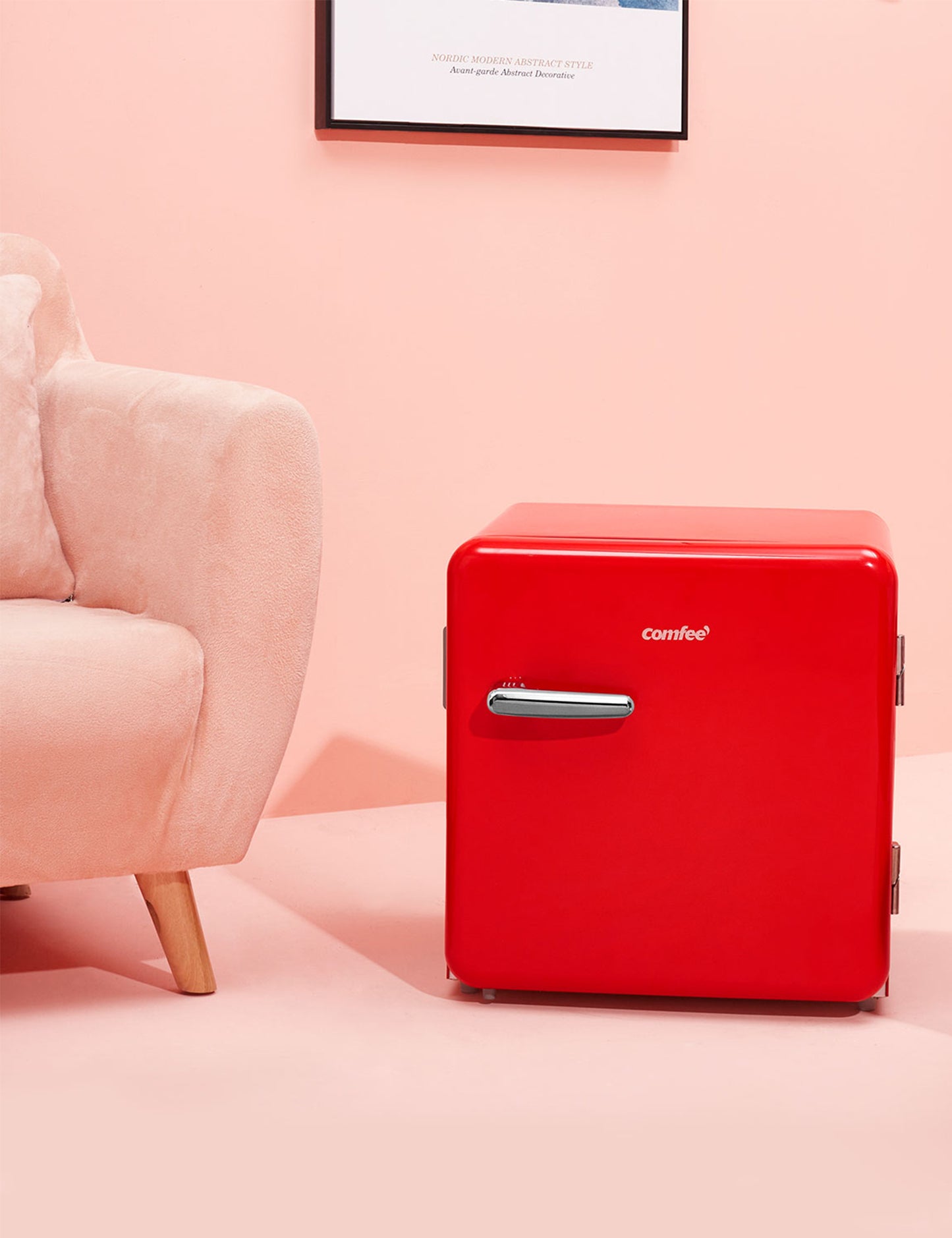 red mini comfee retro fridge on the floor in a stylish interior