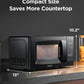 size dimensions of black comfee compact microwave oven on a black kitchen countertop