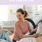 A woman smiles and takes clothes out of the comfee washing machine
