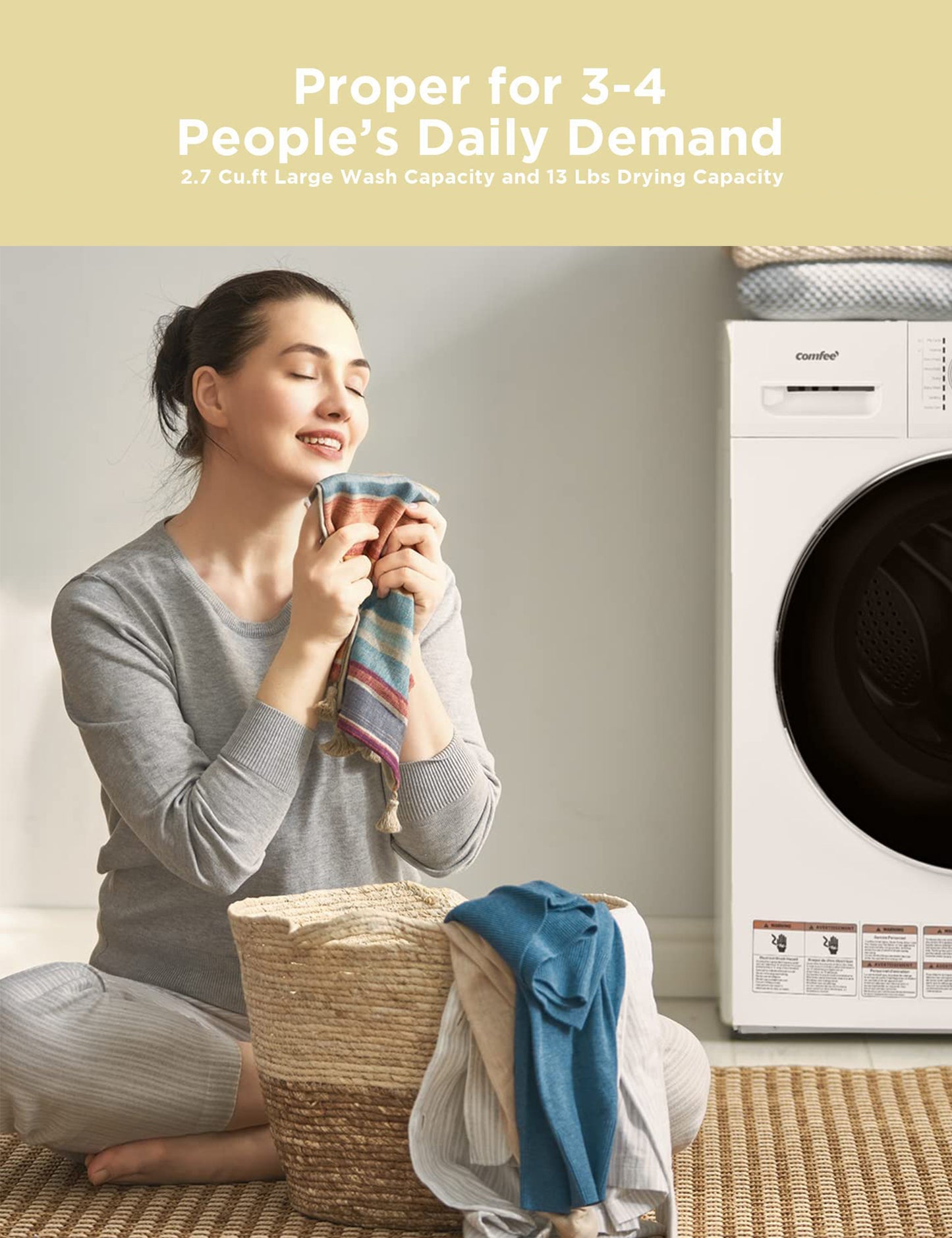 a woman closes her eyes to feel the smell of clothes with a washer and dryer combo next to her