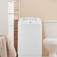 white comfee portable washing machine next to a toilet