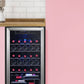 clear glass wine cooler with wine inside under a cabinet in a pink interior