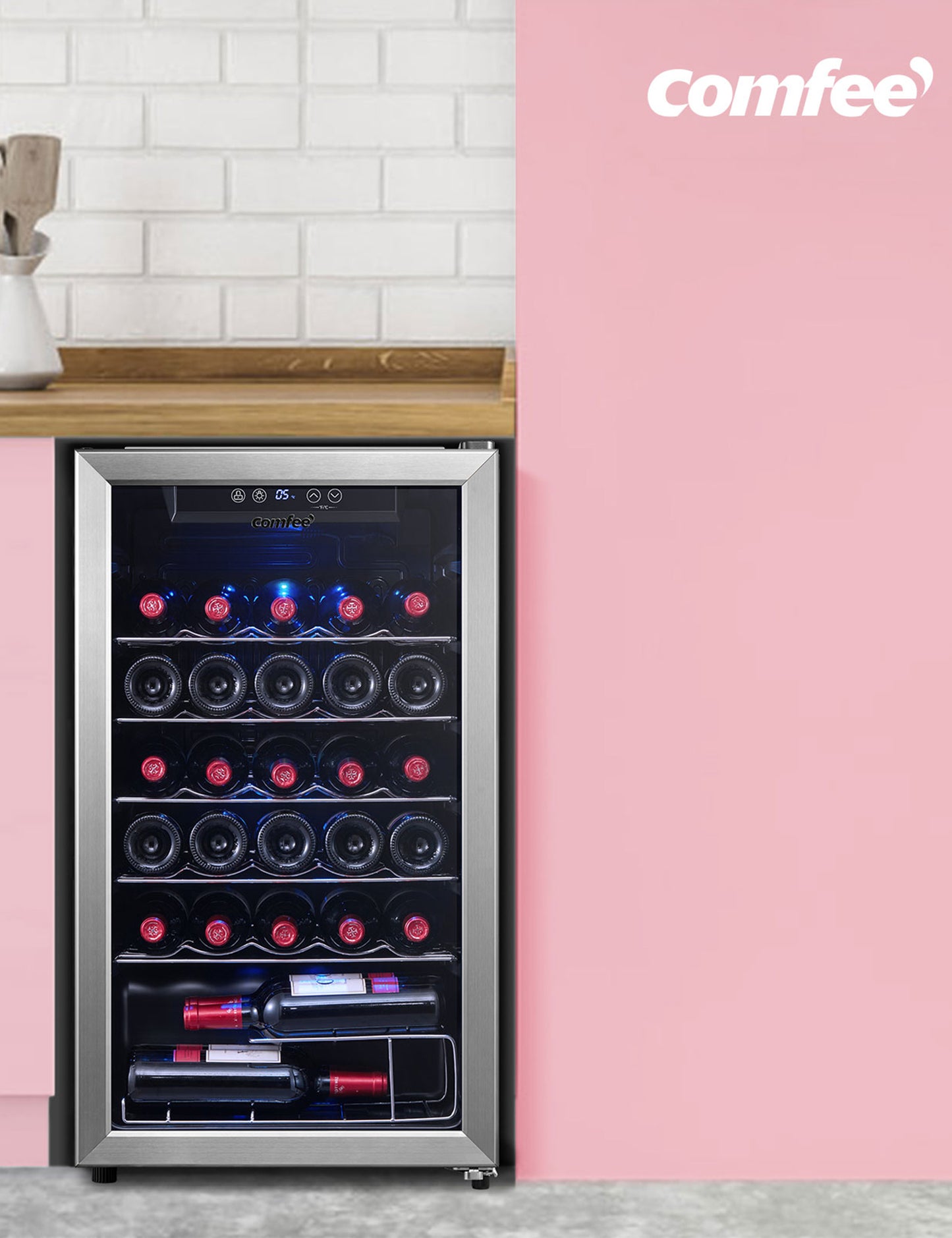 clear glass wine cooler with wine inside under a cabinet in a pink interior